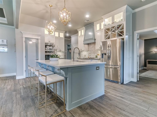 12801 Red Spruce Cir, Oklahoma City, OK 73142 - kitchen featuring appliances with stainless steel finishes, a sink, ornamental molding, a chandelier, and decorative backsplash