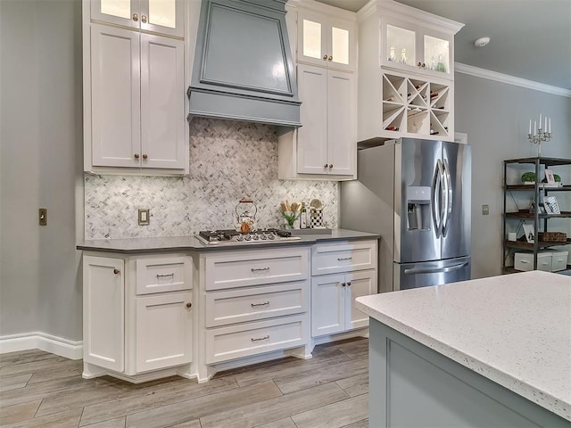 12801 Red Spruce Cir, Oklahoma City, OK 73142 - kitchen with stainless steel appliances, custom exhaust hood, backsplash, ornamental molding, and light wood-style flooring
