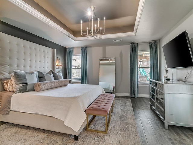 12801 Red Spruce Cir, Oklahoma City, OK 73142 - bedroom with a raised ceiling, a chandelier, multiple windows, and baseboards