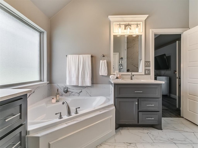 12801 Red Spruce Cir, Oklahoma City, OK 73142 - bathroom with vanity, a garden tub, marble look tile flooring, and vaulted ceiling