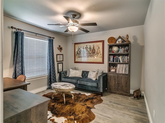 12801 Red Spruce Cir, Oklahoma City, OK 73142 - living room featuring a ceiling fan, wood finished floors, and baseboards