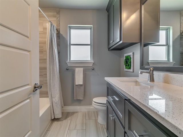 12801 Red Spruce Cir, Oklahoma City, OK 73142 - bathroom featuring vanity, toilet, baseboards, and shower / bath combo with shower curtain
