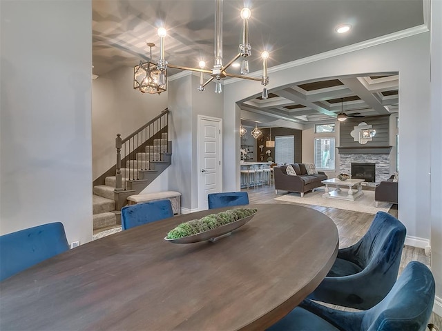 12801 Red Spruce Cir, Oklahoma City, OK 73142 - dining area with coffered ceiling, stairs, a chandelier, ceiling fan, and a stone fireplace