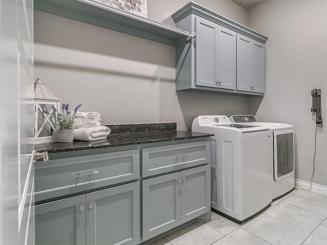 12801 Red Spruce Cir, Oklahoma City, OK 73142 - laundry area featuring cabinet space, washer and clothes dryer, and baseboards