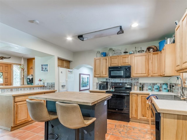 43 W Shore Dr, Arcadia, OK 73007 - kitchen featuring black appliances, arched walkways, a center island, tasteful backsplash, and recessed lighting