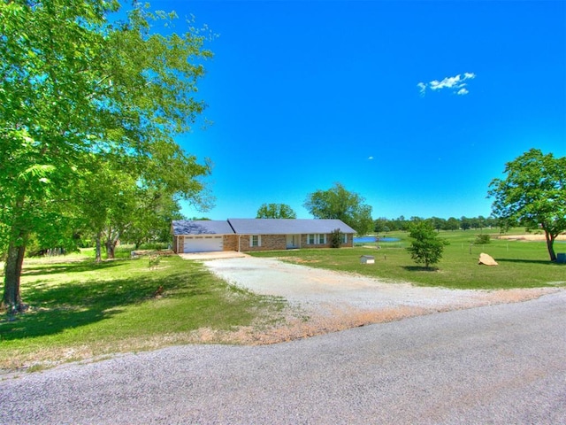 18 Whispering Meadows Rd, Shawnee, OK 74804 - ranch-style home featuring driveway, a front lawn, and a garage