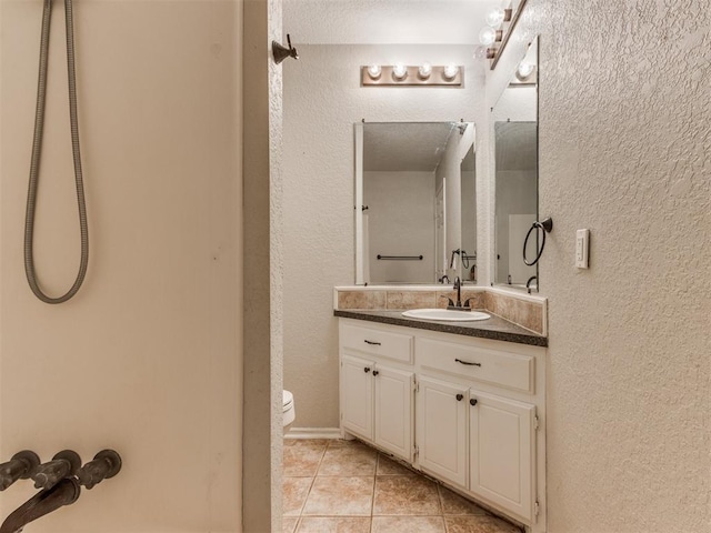 18 Whispering Meadows Rd, Shawnee, OK 74804 - bathroom with tile patterned flooring, vanity, toilet, and a textured wall