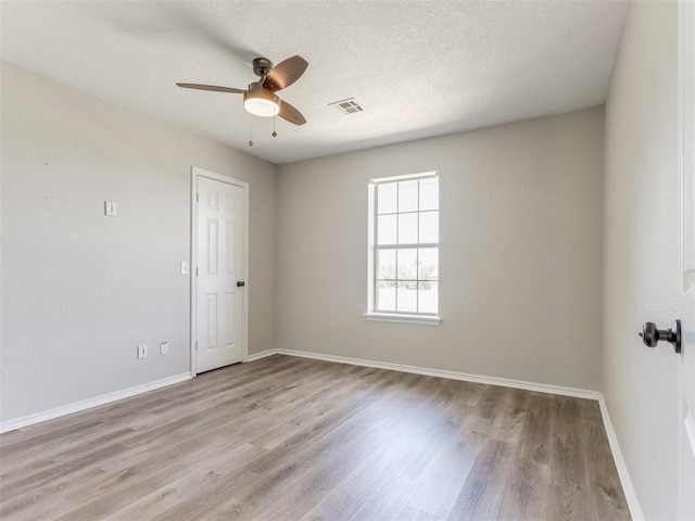 18 Whispering Meadows Rd, Shawnee, OK 74804 - spare room with a ceiling fan, light wood-type flooring, baseboards, and a textured ceiling