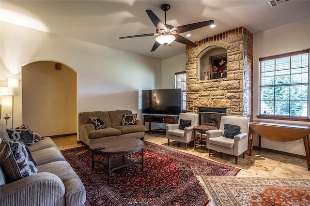 3417 Lyle Rd, Weatherford, OK 73096 - living room featuring healthy amount of natural light, ceiling fan, a fireplace, recessed lighting, and arched walkways