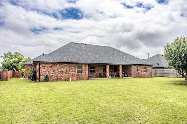 3417 Lyle Rd, Weatherford, OK 73096 - back of house with roof with shingles, a patio area, and brick siding
