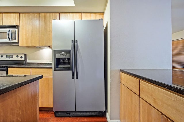 600 NW 4th St Unit 319N, Oklahoma City, OK 73102 - kitchen with stainless steel appliances, dark stone countertops, and light brown cabinets