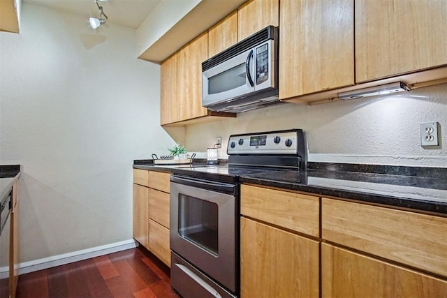 600 NW 4th St Unit 319N, Oklahoma City, OK 73102 - kitchen featuring stainless steel appliances, dark wood-type flooring, light brown cabinetry, and dark stone counters