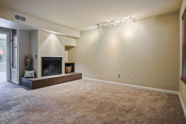 600 NW 4th St Unit 319N, Oklahoma City, OK 73102 - unfurnished living room featuring carpet flooring and a fireplace with raised hearth