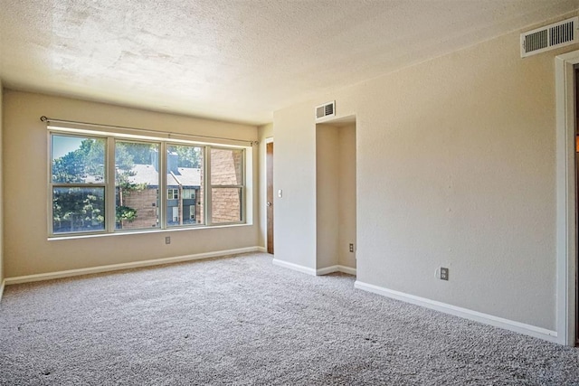 600 NW 4th St Unit 319N, Oklahoma City, OK 73102 - spare room with a textured ceiling, carpet, and a textured wall