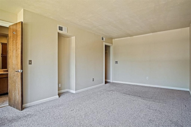 600 NW 4th St Unit 319N, Oklahoma City, OK 73102 - unfurnished bedroom with carpet flooring and a textured ceiling