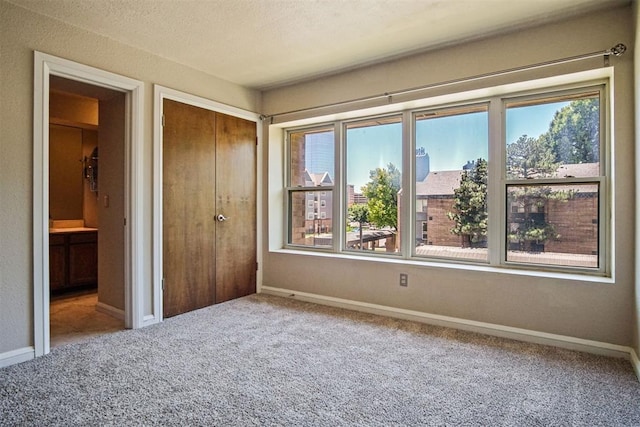 600 NW 4th St Unit 319N, Oklahoma City, OK 73102 - unfurnished bedroom featuring carpet flooring and a closet
