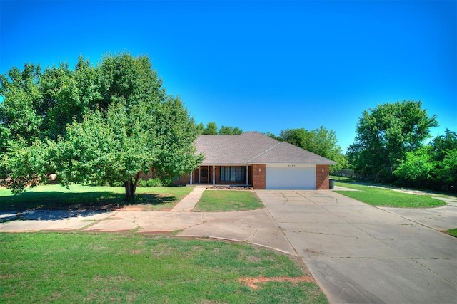 4205 Sooner Cir, Edmond, OK 73034 - ranch-style house with an attached garage, concrete driveway, a front lawn, and brick siding