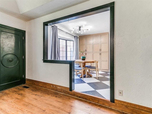 4205 Sooner Cir, Edmond, OK 73034 - entryway featuring baseboards, wood finished floors, and a textured wall