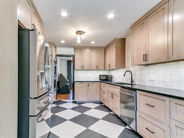 4205 Sooner Cir, Edmond, OK 73034 - kitchen with stainless steel appliances, a sink, dark floors, light brown cabinetry, and dark countertops