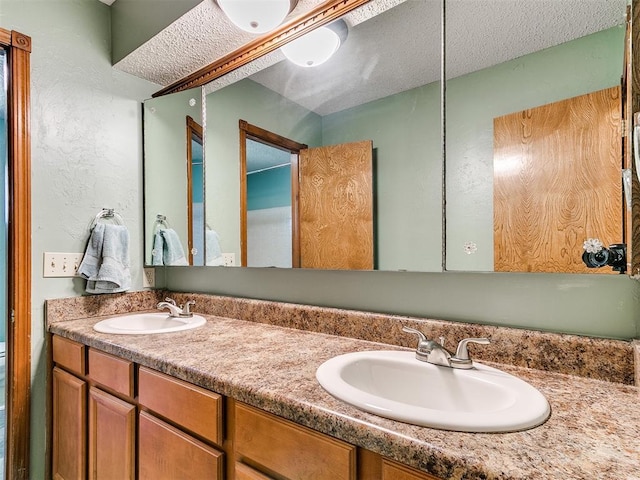 4205 Sooner Cir, Edmond, OK 73034 - bathroom featuring double vanity and a textured ceiling