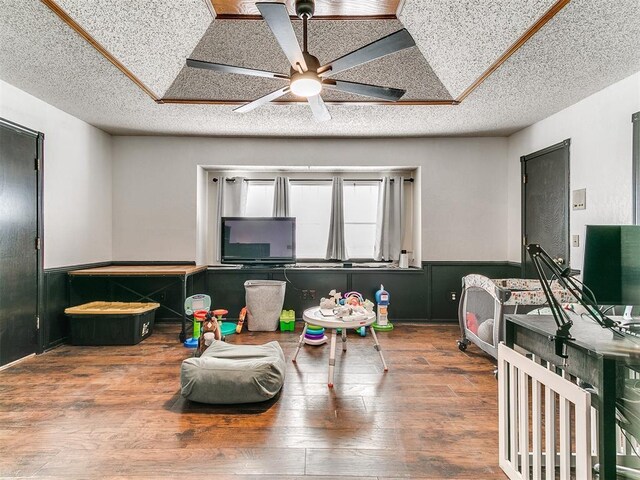 4205 Sooner Cir, Edmond, OK 73034 - rec room with a ceiling fan, a textured ceiling, and wood finished floors