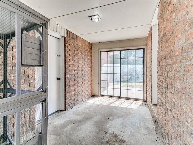 4205 Sooner Cir, Edmond, OK 73034 - empty room with brick wall and unfinished concrete floors