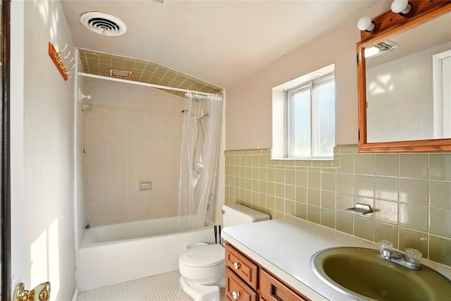 6005 NW Kingston Rd, Oklahoma City, OK 73122 - full bathroom with toilet, tile walls, vanity, shower / bath combo with shower curtain, and tile patterned floors