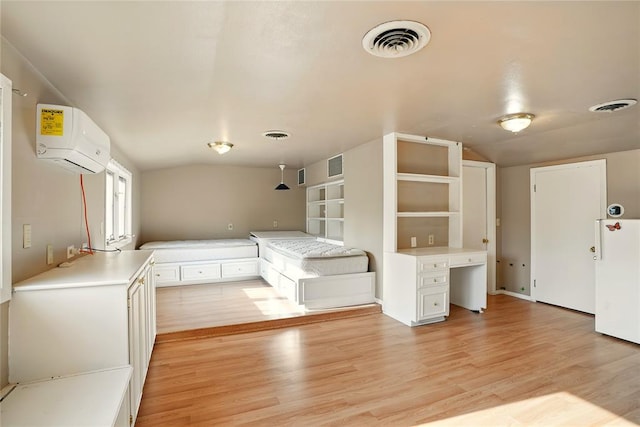6005 NW Kingston Rd, Oklahoma City, OK 73122 - unfurnished bedroom featuring lofted ceiling, an AC wall unit, and light wood-style floors