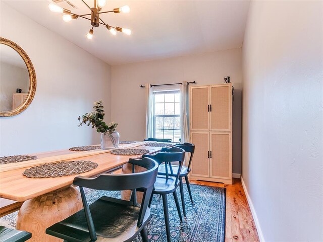 1604 NW 29th St, Oklahoma City, OK 73106 - dining room featuring a chandelier, light wood-type flooring, and baseboards