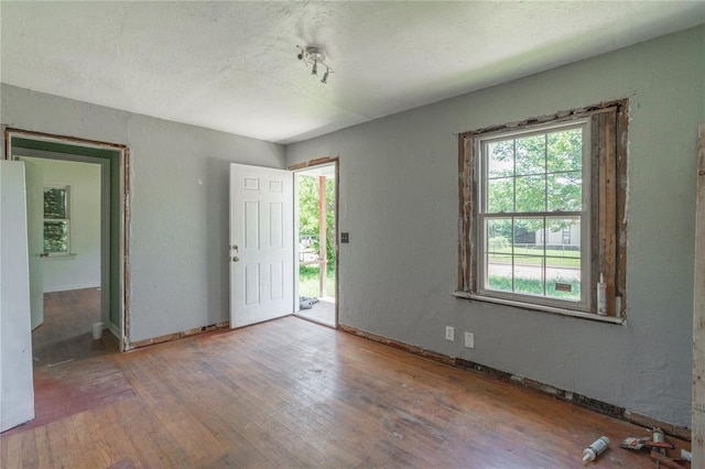 3917 SE 12th St, Oklahoma City, OK 73115 - entryway featuring wood finished floors, a textured ceiling, and baseboards