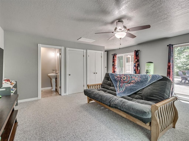 5101 Long Branch Ln, Edmond, OK 73034 - carpeted living area with ceiling fan and a textured ceiling