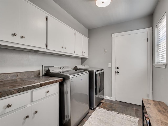 5101 Long Branch Ln, Edmond, OK 73034 - laundry area with washing machine and clothes dryer, cabinet space, and dark stone finish flooring