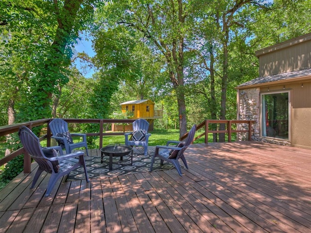 5101 Long Branch Ln, Edmond, OK 73034 - wooden deck featuring an outdoor fire pit and a storage shed