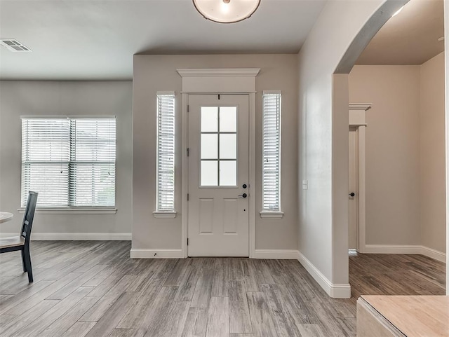 5608 Courtland Ln, Choctaw, OK 73020 - entryway featuring wood finished floors, arched walkways, and baseboards
