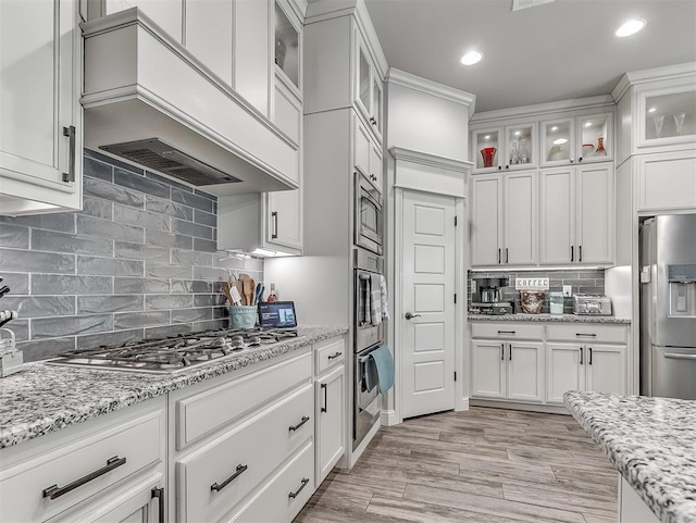 5608 Courtland Ln, Choctaw, OK 73020 - kitchen with stainless steel appliances, custom range hood, white cabinets, tasteful backsplash, and recessed lighting