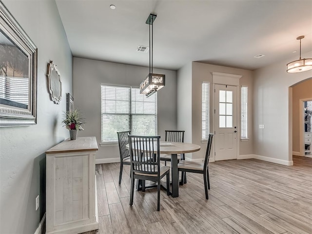 5608 Courtland Ln, Choctaw, OK 73020 - dining room with light wood-style floors, arched walkways, and baseboards
