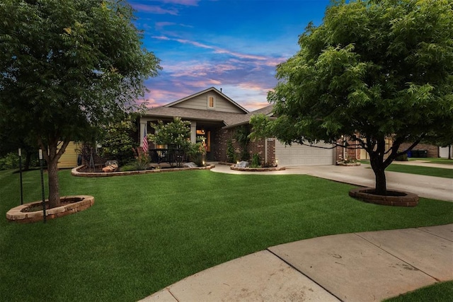 603 Sedona Dr, Norman, OK 73071 - view of property hidden behind natural elements featuring concrete driveway, a lawn, an attached garage, covered porch, and brick siding
