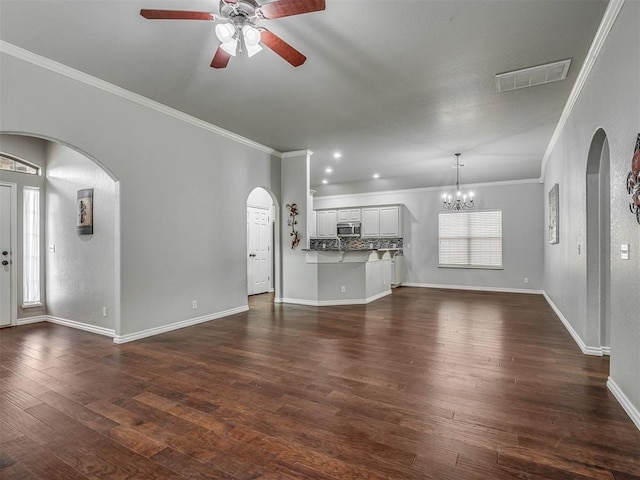 4033 NE 138th St, Edmond, OK 73013 - unfurnished living room with a ceiling fan, arched walkways, crown molding, dark wood-style floors, and baseboards