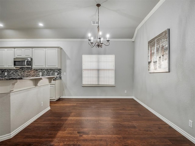 4033 NE 138th St, Edmond, OK 73013 - unfurnished dining area featuring ornamental molding, a chandelier, dark wood-type flooring, and baseboards