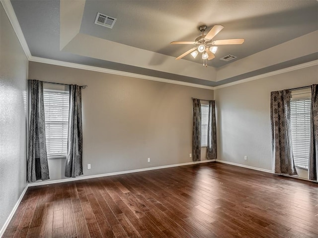 4033 NE 138th St, Edmond, OK 73013 - empty room featuring a raised ceiling, ceiling fan, wood-type flooring, and crown molding