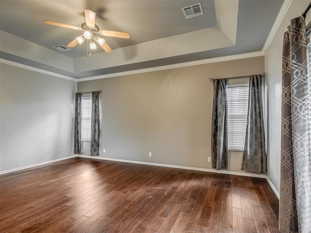 4033 NE 138th St, Edmond, OK 73013 - spare room with a raised ceiling, plenty of natural light, a ceiling fan, dark wood-style flooring, and ornamental molding