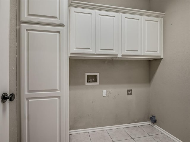 4033 NE 138th St, Edmond, OK 73013 - laundry room with hookup for a washing machine, electric dryer hookup, baseboards, light tile patterned floors, and cabinet space