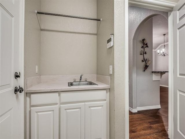 4033 NE 138th St, Edmond, OK 73013 - bathroom with wood finished floors, baseboards, vanity, and a chandelier