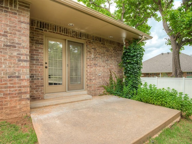 4033 NE 138th St, Edmond, OK 73013 - view of exterior entry with brick siding and a patio
