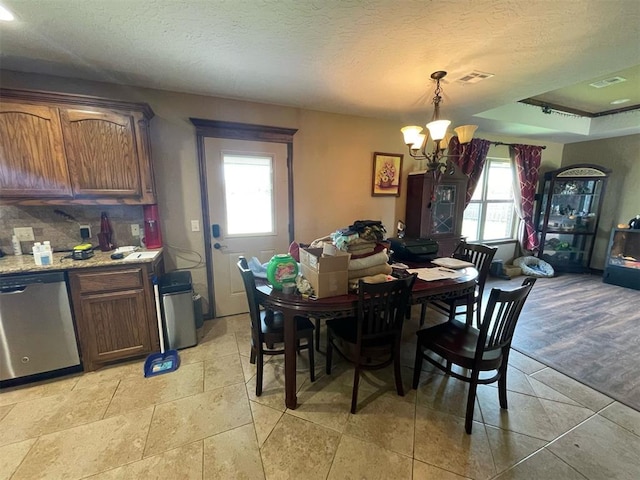 103 Thurman Dr, Walters, OK 73572 - dining space with healthy amount of natural light, a chandelier, and a textured ceiling