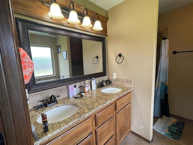 103 Thurman Dr, Walters, OK 73572 - bathroom featuring double vanity, baseboards, and curtained shower