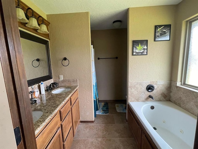 103 Thurman Dr, Walters, OK 73572 - full bathroom with a tub with jets, a textured wall, healthy amount of natural light, double vanity, and a shower with shower curtain