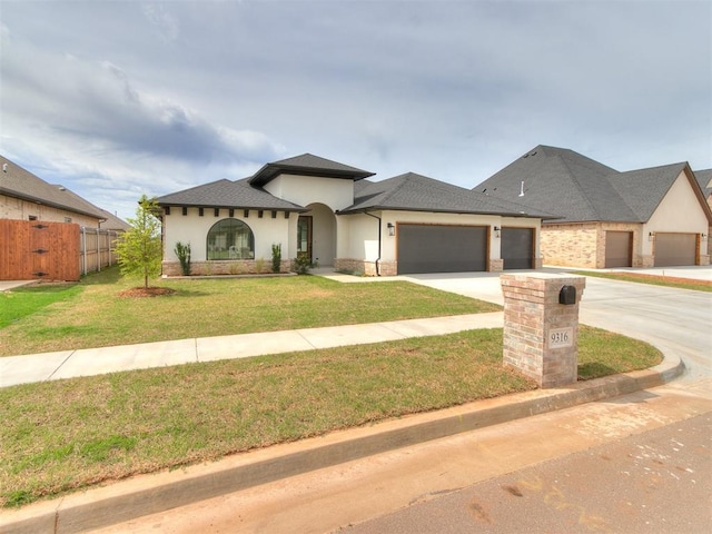 9316 NW 84th St, Yukon, OK 73099 - view of front of home with an attached garage, stucco siding, concrete driveway, and stone siding