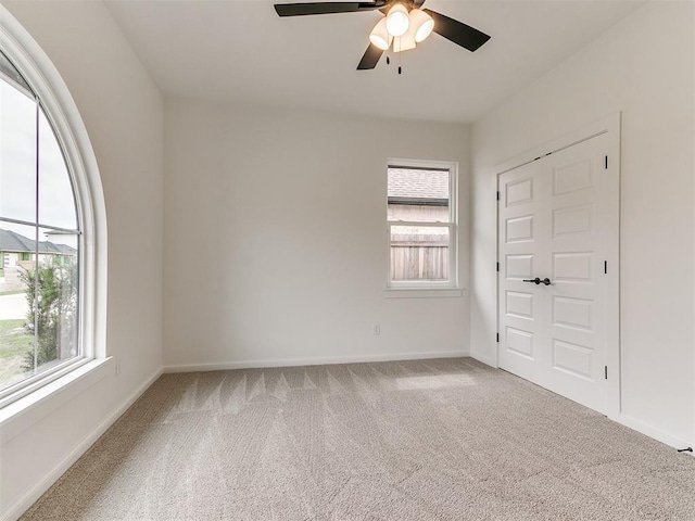 9316 NW 84th St, Yukon, OK 73099 - unfurnished bedroom featuring multiple windows, carpet flooring, baseboards, and ceiling fan