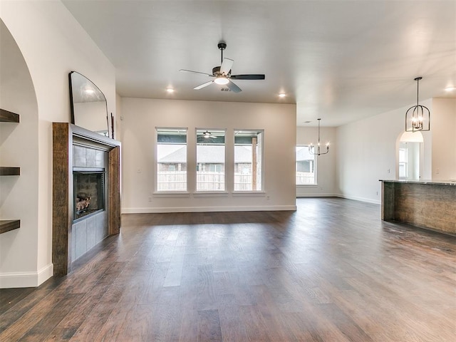 9316 NW 84th St, Yukon, OK 73099 - unfurnished living room with ceiling fan, a fireplace, a chandelier, dark wood finished floors, and recessed lighting